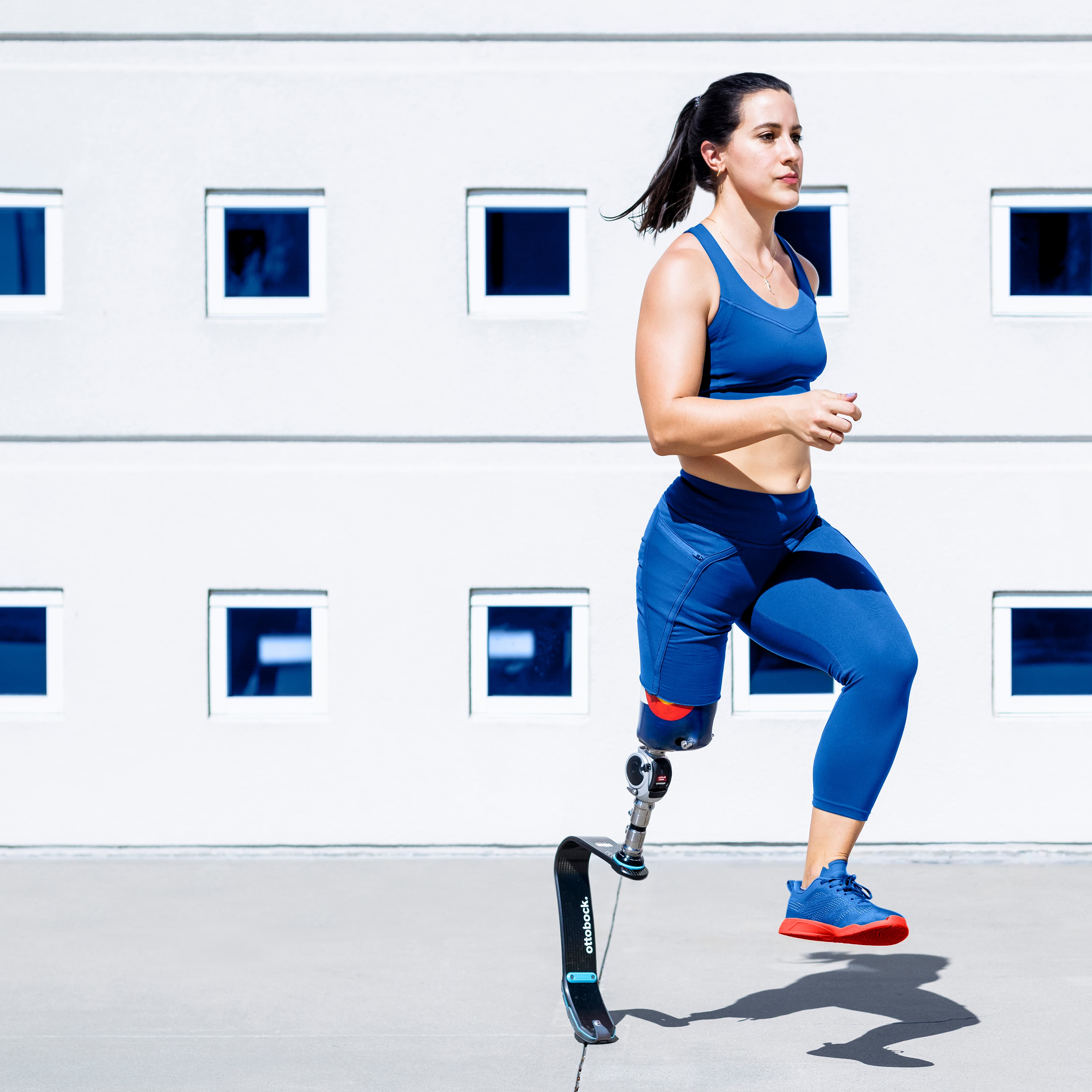 Athletic woman with prosthetic leg running